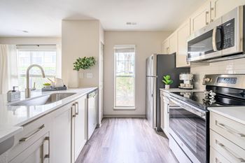 A modern kitchen with stainless steel appliances and white cabinets